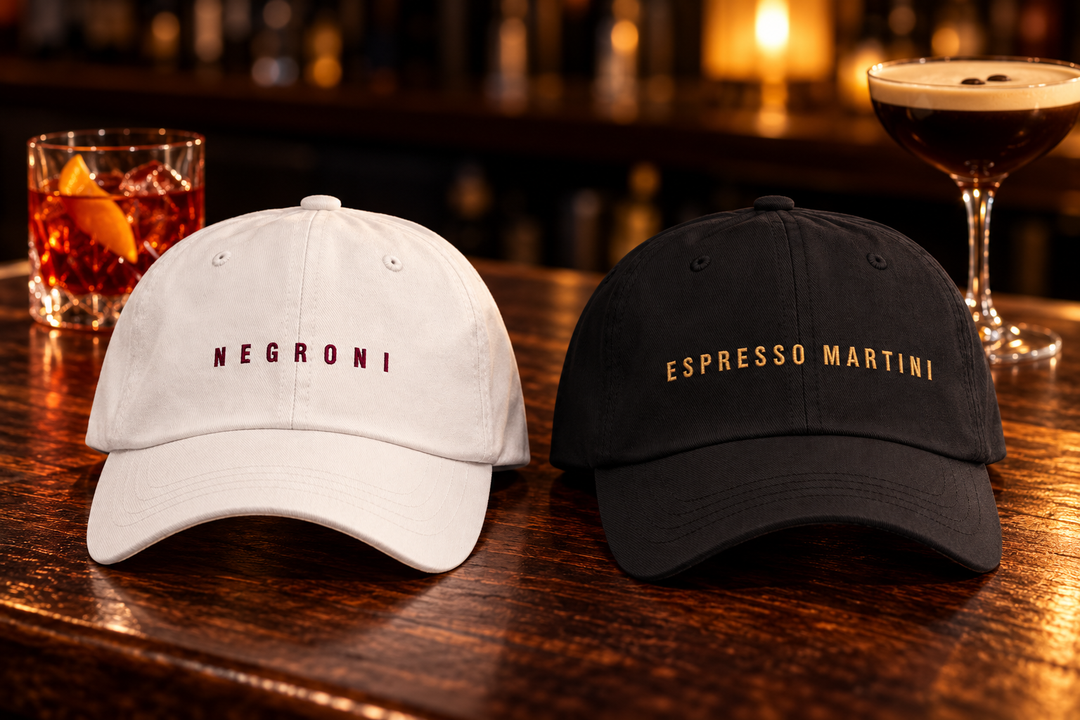 White Negroni cap and black Espresso Martini cap on a wooden bar